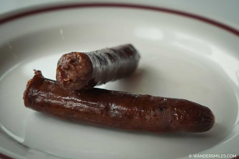 Two Cypriot Sausages on a white plate. A traditional Cypriot recipe.