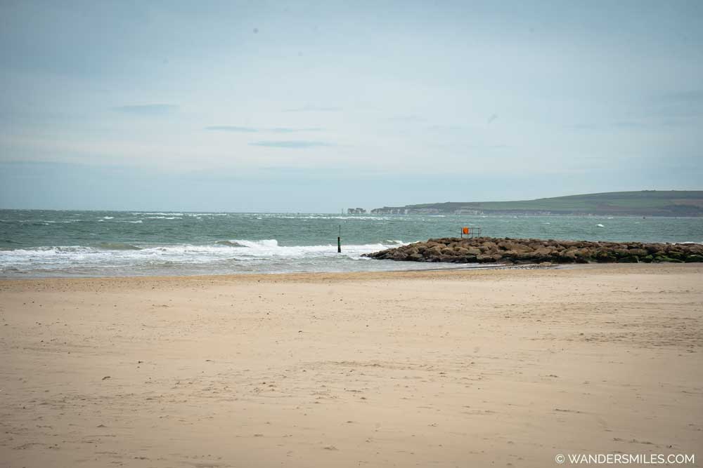 Sandbanks Beach in Bournemouth. Photo of a golden beach with waves from the sea.