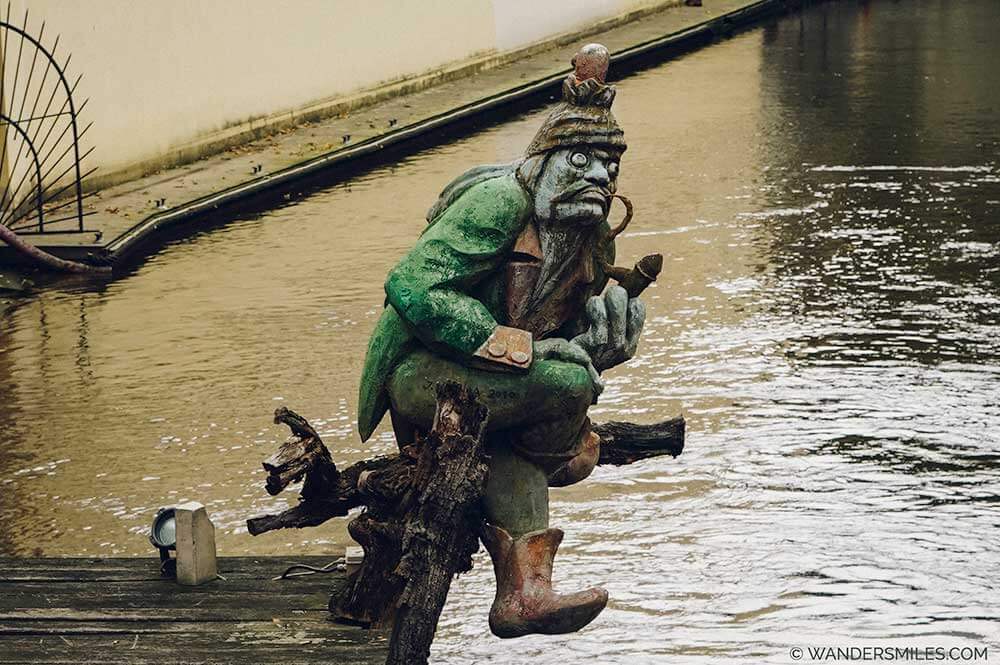 Photo of a statue of Kabourek - a water goblin guarding an old mill on the Devil's Stream in Prague.