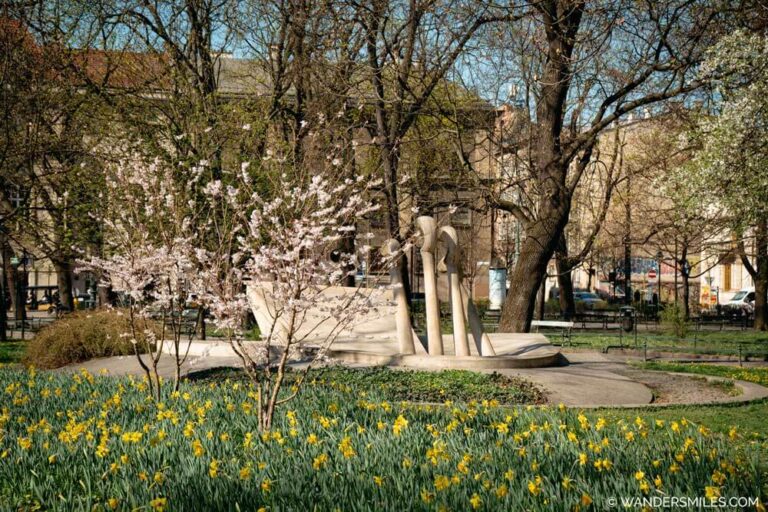 Spring in Krakow: Chopin's Piano Water Fountain in Planty surrounded by blossom and daffodils