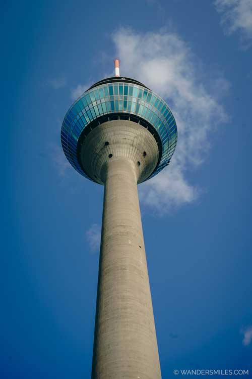 The Rhine Tower is a tall, iconic skyscraper in Düsseldorf that resembles a slender, cylindrical tower with a distinctive top
