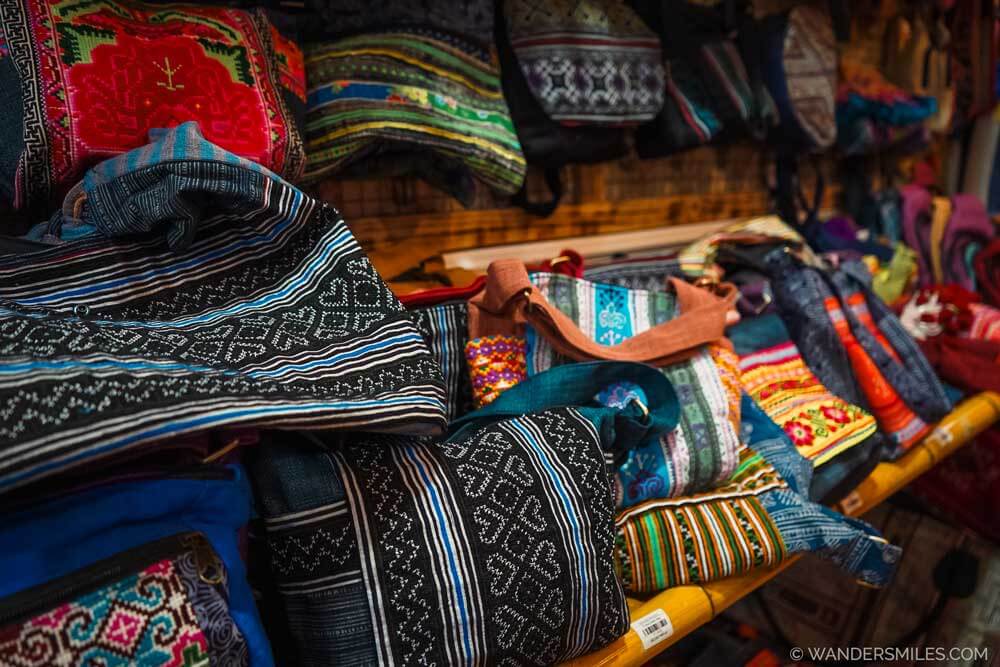 Shelves of H'mong embroidered and brocade-woven bags in a shop in Sapa, Vietnam