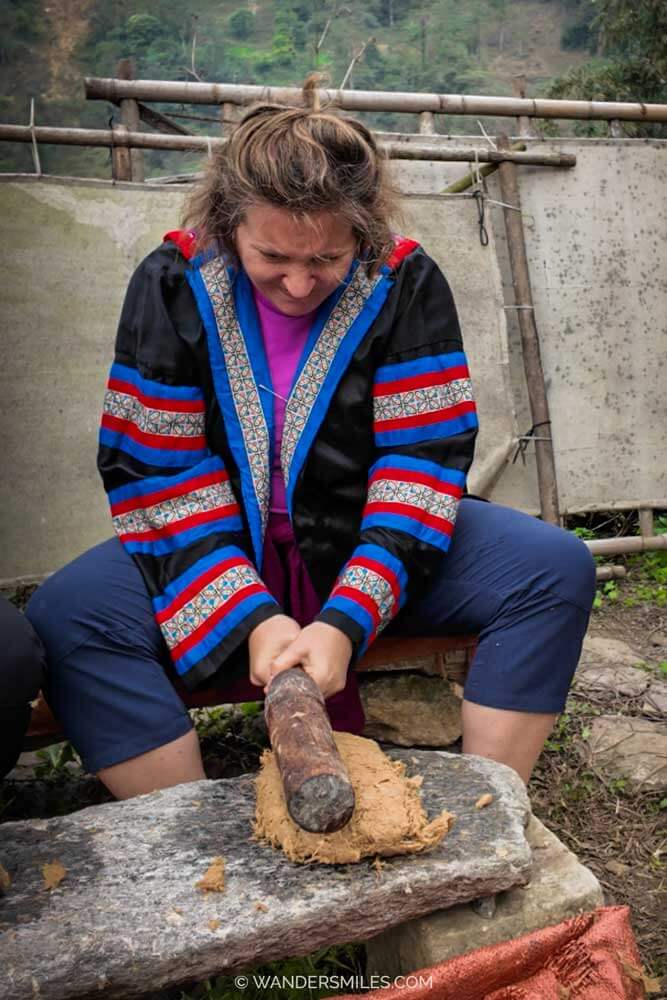 Woman pounding pulp to make bamboo paper in the villages of Sapa, Vietnam