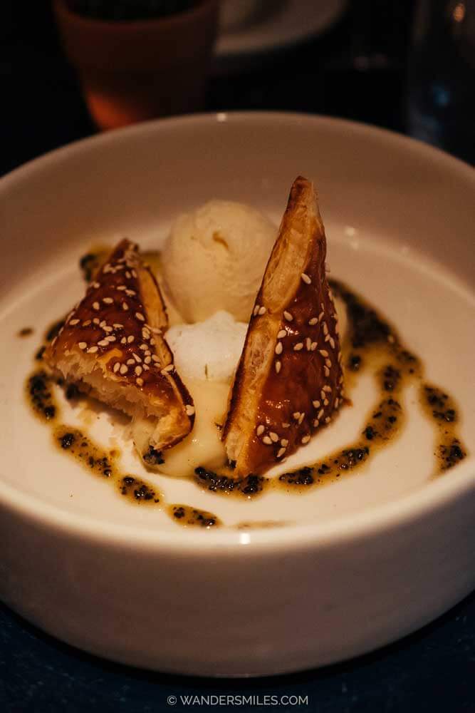 Lemon and basil puff pastry dessert with Ice Cream, served in a white bowl at Le Jardin, Utrecht