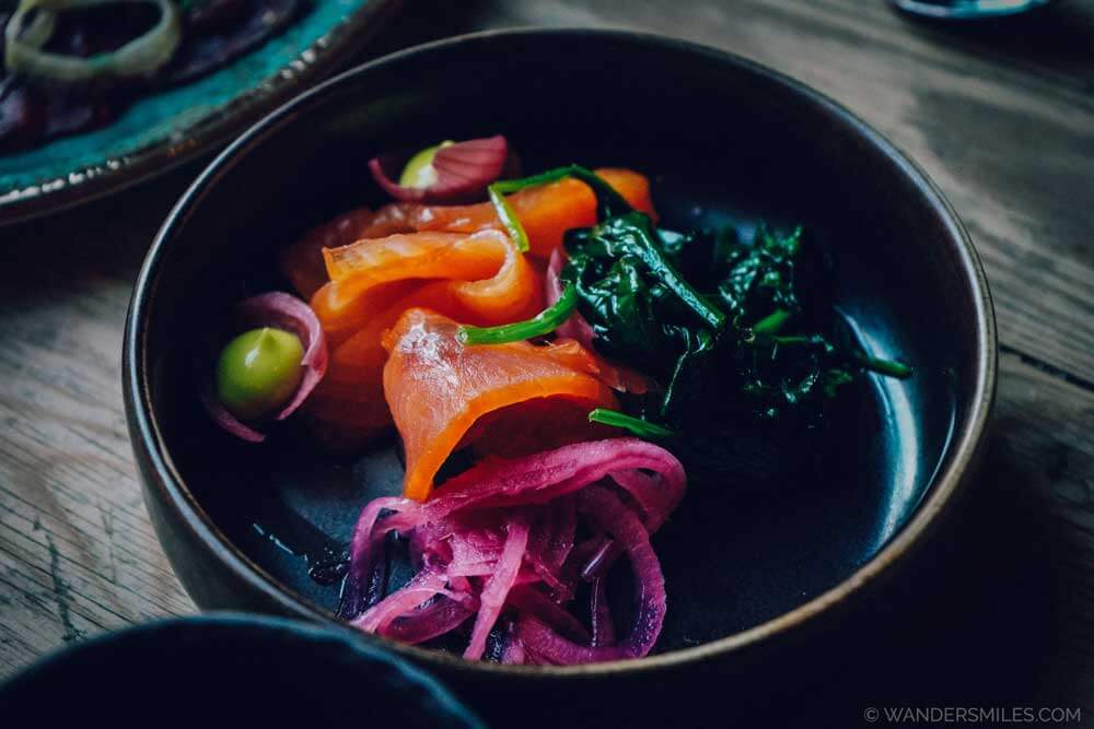 Dark bowl with aquavit-marinated salmon in Bryggen Tracteursted restaurant in Bergen, Norway