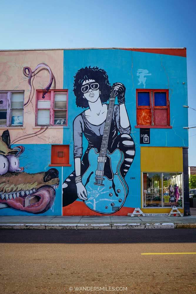 Mural with a woman on a guitar, by artist Erre, in Clarksdale, Mississippi