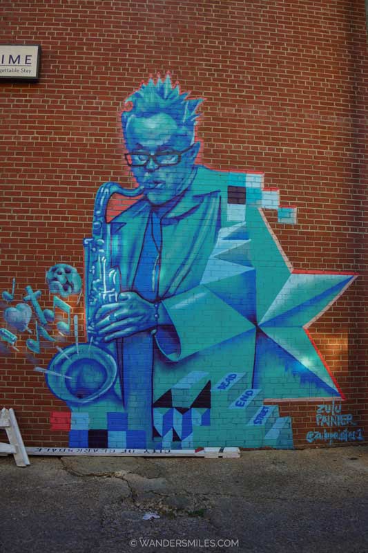 A blue mural of Stan Street (owner of Hambone, Clarksdale) playing a saxophone