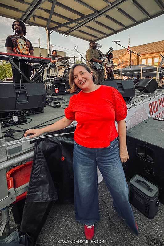 Woman in red top by the stage where Kingfish is performing in the Juke Joint Festival in Clarksdale, Mississippi.