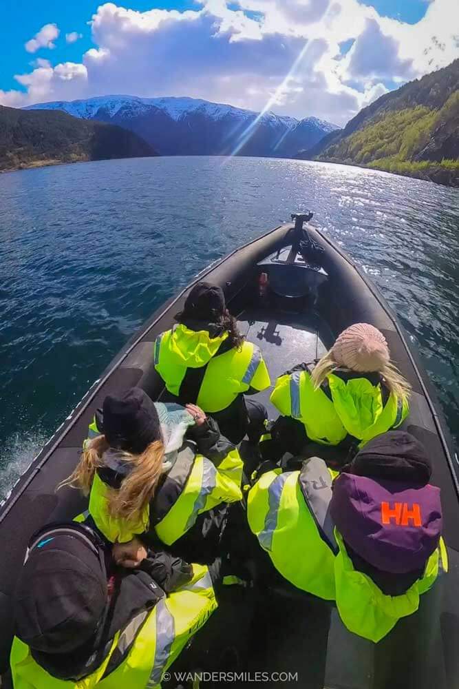 RIB Boat Safari in Hardangerfjord. Photo taken from above with people in high-vis coats and hats