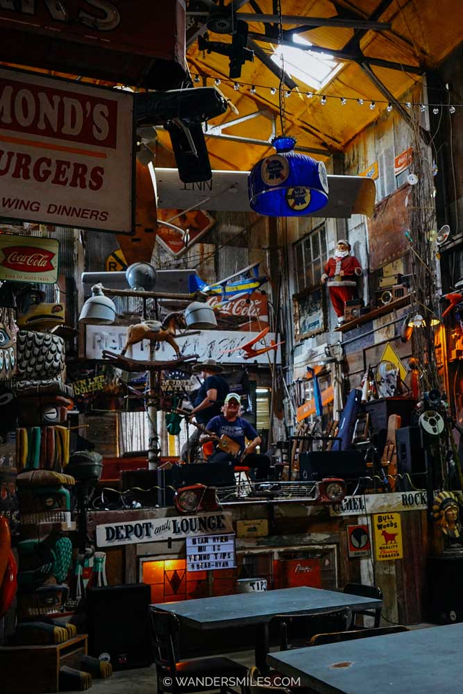 Music and pool room at the Shack Up Inn, Clarksdale, with a mass of quirky signage and vintage objects on the walls and hanging down from the ceiling