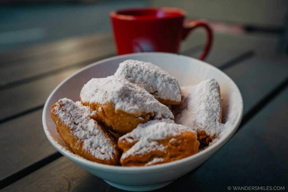 Bowl of Beignets, deep-fried pastries with a heavy dusting of icing sugar
