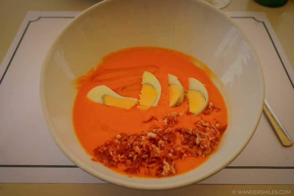 Bowl of Salmorejo, a traditional cold tomato soup originating from Córdoba. Served with diced Spanish ibérico ham and diced hard-boiled eggs.