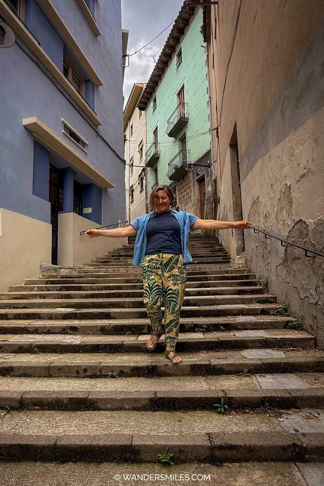 A Woman (Vanessa) happily walking down the steep steps in Girona, Spain