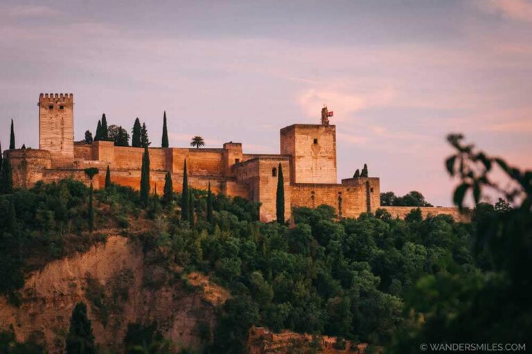 Sunset views of Alhambra, Granada, from Las Tomases restaurant. One of the most iconic views on our Spain by train adventure.