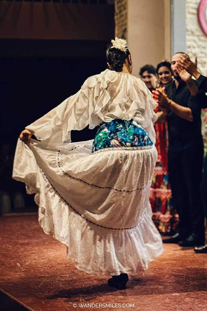 Flamenco dancer in a white dress performing at Seville's Museo del Baile Flamenco (Flamenco Dance Museum)