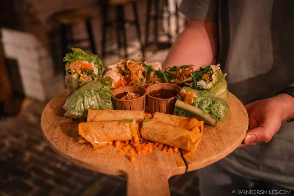 Sharing platter of Vietnamese rolls on a wooden board from Vietnamama in Down Town Market Eindhoven