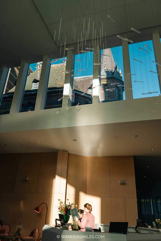 Lobby of Hotel Mariënhage Eindhoven, showing reception desk and light installation by local artist and sky light.