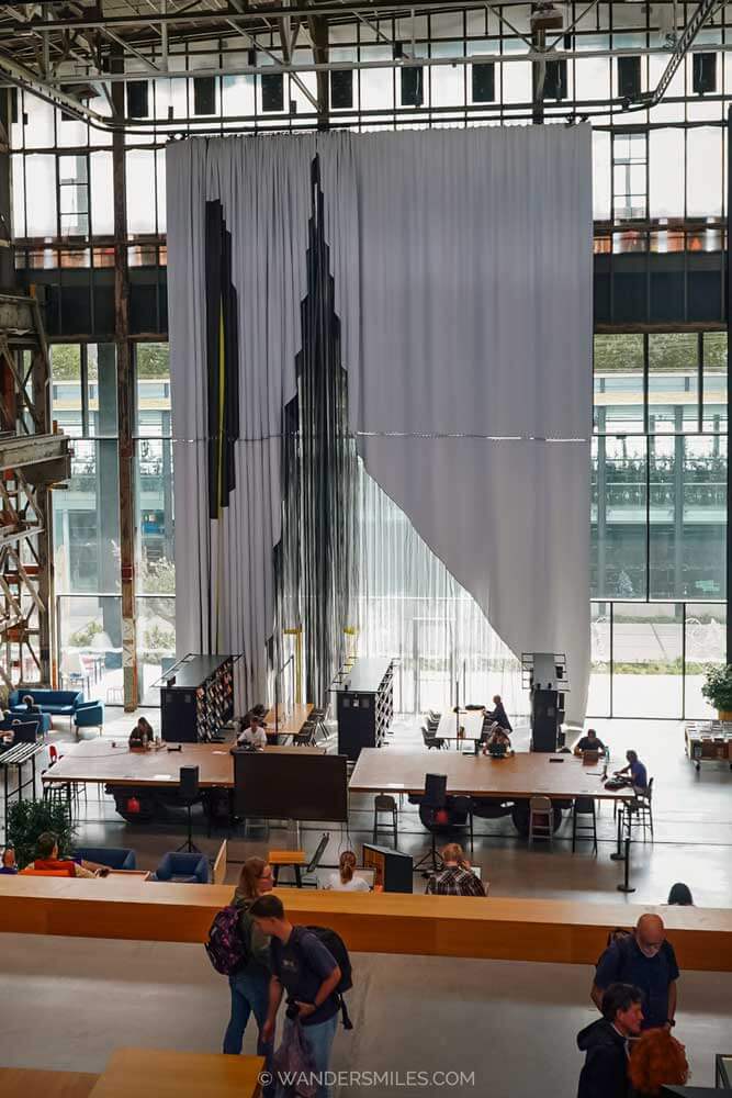 Draped textile installation made in TextielLab, against huge window in LocHal, Tilburg