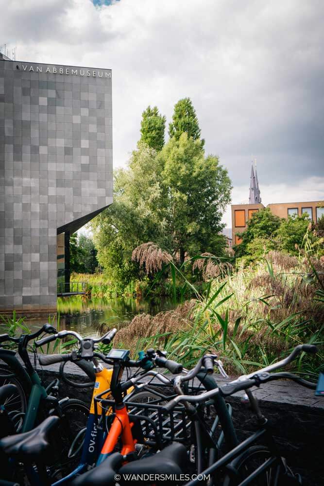 Exterior of grey geometric building of Van Abbemuseum Eindhoven with bikes in the forefront